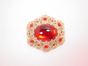 German Aluminum Filigree and Red Rhinestone Pin
